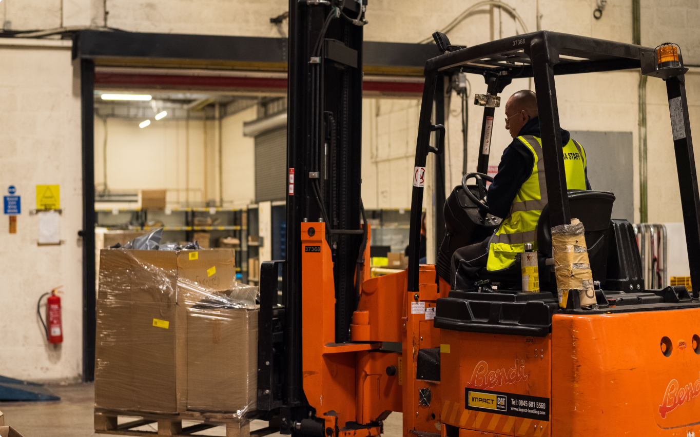 Warehouse worker operating a forklift